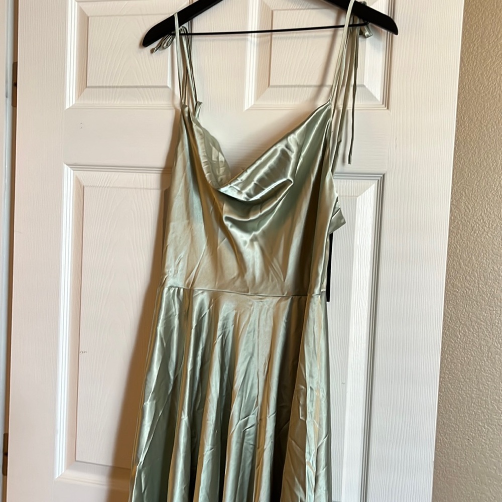 Long satin dress. Opens in front tie at shoulders